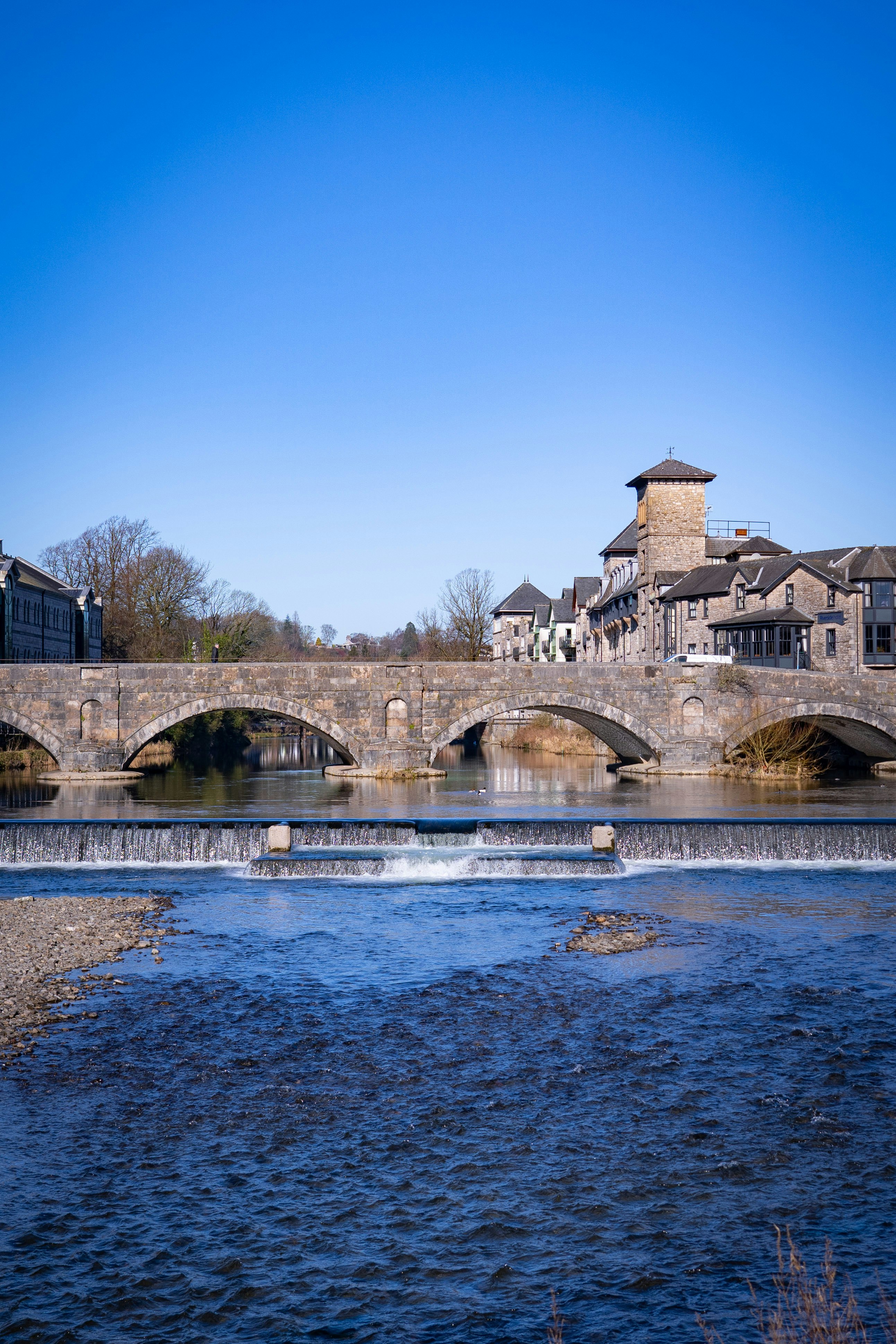 brown concrete bridge over river during daytime